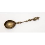 An unmarked cast white metal commemorative spoon, indications of punch marks or hallmarks but not