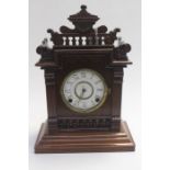A late Victorian mantle clock with enamel face, key is taped to the top of the clock