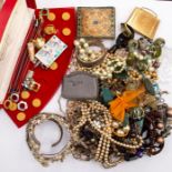 A collection of costume jewellery including yellow metal and silver items, pearls, beads, compacts