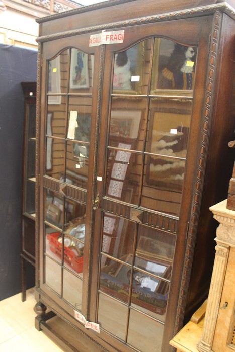 An early 20th Century oak glazed bookcase.