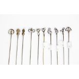 A collection of ten Charles Horner silver hat pins, various organic designs, along with Grenadier