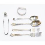 A collection of silver flatware, including spoons, thimble, 3.86 ozt approx