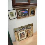 A collection of pub advertising mirrors and prints