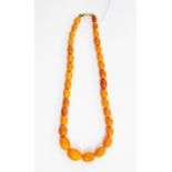 A butterscotch amber bead necklace, graduated oval beads, total gross weight approx 49.9 grams