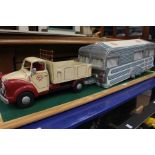 A wooden model of a truck and caravan, on wooden base