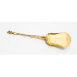 A yellow metal silver gilt spoon, with crest to the reverse, possibly late 18th Century, untested,