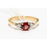 An 18ct gold, red spinel and diamond three stone ring, size P, approx 4.1gms, with certificate