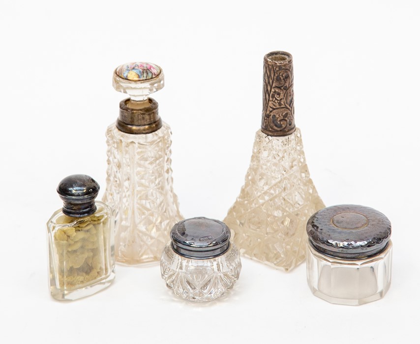 A collection of glass silver topped dressing table bottles