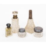 A collection of glass silver topped dressing table bottles