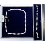 A cultured pearl necklace, knotted with 9ct gold clasp along with matching bracelet (2)