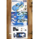 A pair of boxed Subaru Impreza WRC, remote controlled.