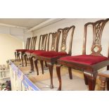 A set of six George III style mahogany dining chairs, wing style back, red velvet seating on