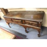 An early 18th century oak dresser base, circa 1710, moulded top, three frieze drawers, on carved