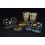 A pair of horn beakers with glass base; two pairs of opera/field glasses, Edwardian period; an