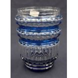 A large blue overlay cut glass vase