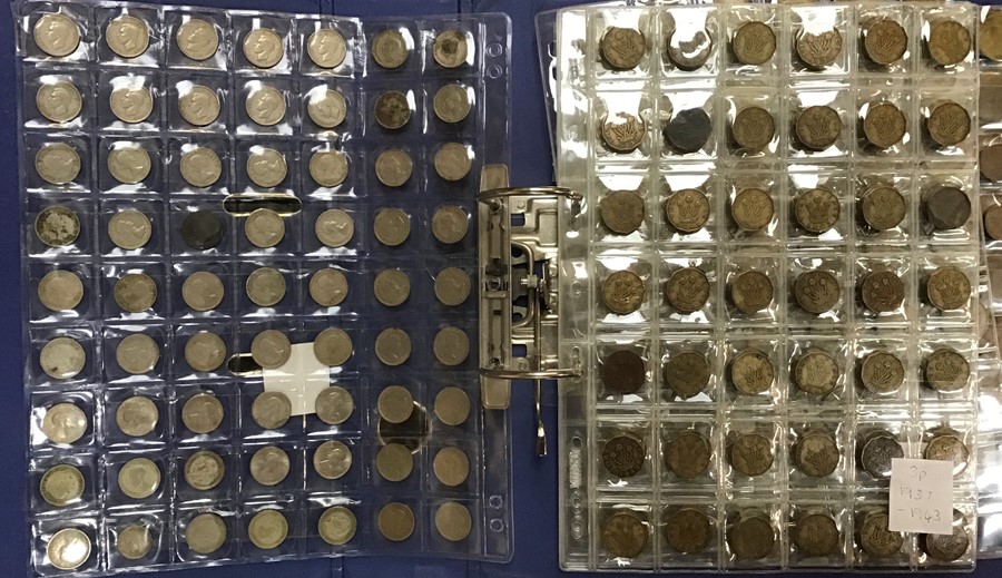 A Large collection of coins and banknotes in two albums and a wooden box.