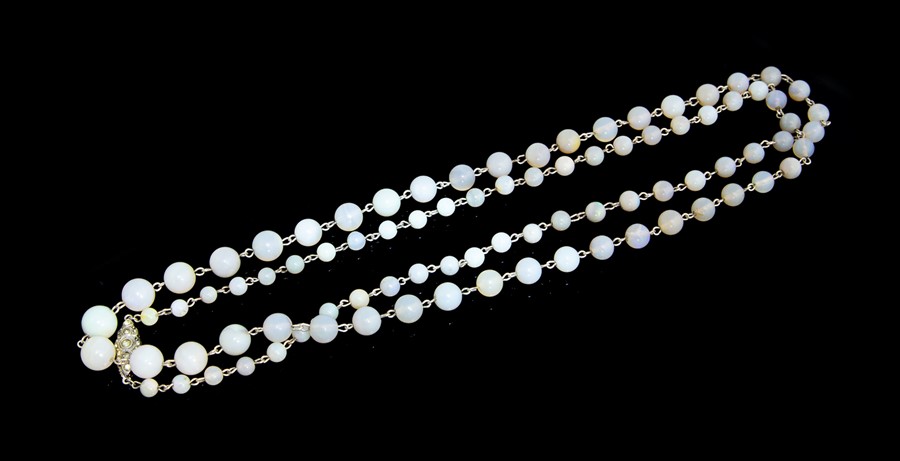 A 1920s opal bead necklace, comprising round graduated beads linked together with silver, beads