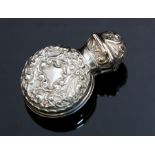 An Edwardian silver cased green perfume bottle and stopper, the silver articulated case opens to