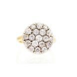 A diamond pave-set round cluster ring, the pave set flat round head comprising a total of nineteen
