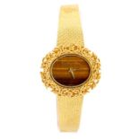 Yves Saint Blaise- an Yves Saint Blaise 18ct gold ladies watch, the oval tigers eye dial within a