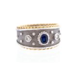 A sapphire and diamond three-stone set 18ct white and yellow gold band, central oval mixed-cut