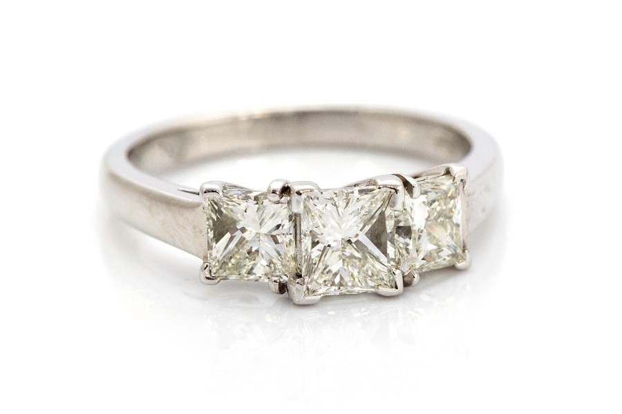 A diamond three stone platinum ring, three princess-cut diamonds total weight approx 1.75carats,