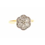 A diamond flowerhead cluster ring, seven principal round brilliant-cut diamonds with border surround