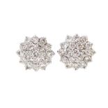 A pair of diamond three-tier cluster stud earrings, nineteen small round brilliant-cut diamonds to