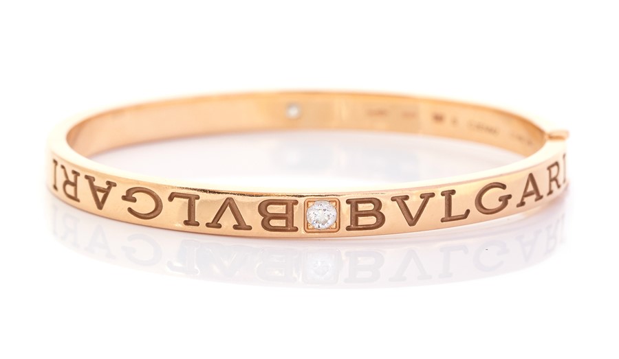 Bvlgari - A Bvlgari diamond two-stone set 18ct yellow gold hinged bangle, two round brilliant cut