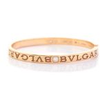 Bvlgari - A Bvlgari diamond two-stone set 18ct yellow gold hinged bangle, two round brilliant cut
