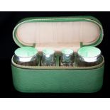 An Art Deco silver and guilloche enamel travelling toilet set including a pair of cologne/perfume