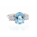 An aquamarine and diamond platinum set ring, the oval aquamarine set to the centre measuring approx.