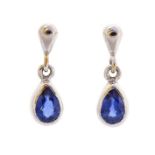 A pair of sapphire and 9ct white gold drop earrings, comprising rub-over set, pear cut sapphires,