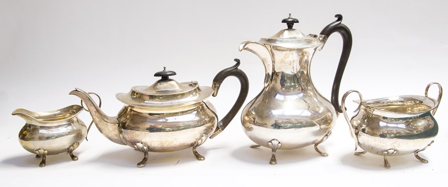 A George V four piece silver tea service, plain bodies on scroll & hoof feet, by Joseph Gloster Ltd,