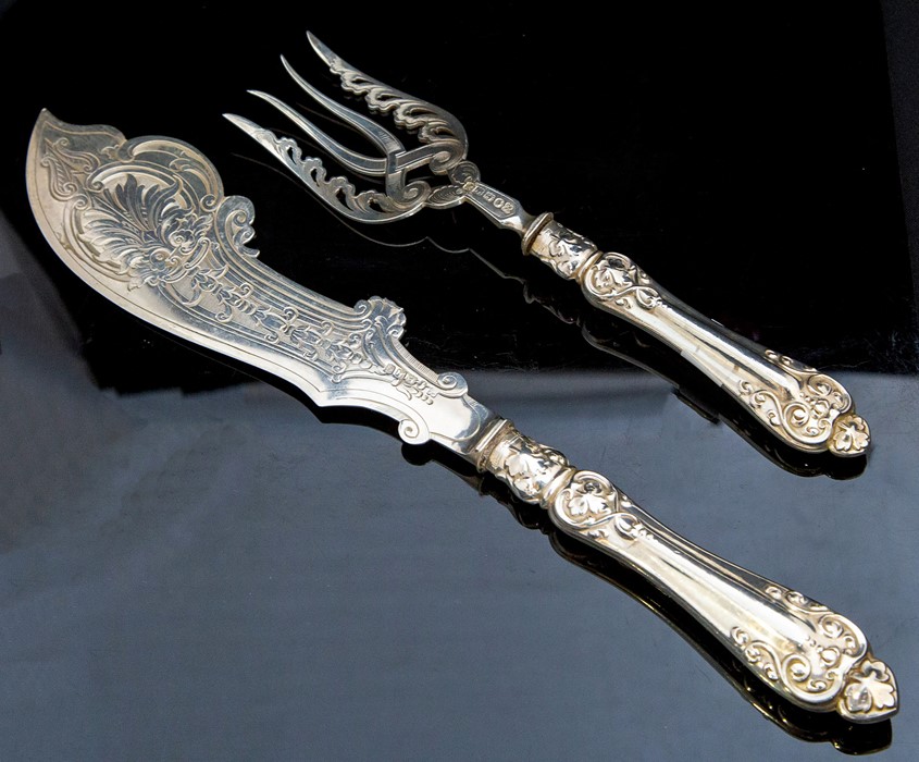 A pair of Victorian provincial silver fish servers, the blade and tines engraved with ornate foliate