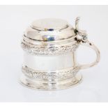 A George III London silver mustard pot and cover, cylinder shaped with raised scrolling border
