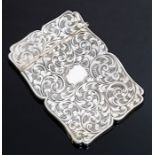 An early Victorian silver card case, the body profusely engraved with scrolling foliage, by