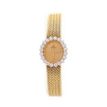 A ladies Omega 14k yellow gold and diamond bracelet dress watch, oval champagne dial with diamond