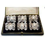 A set of six Continental silver napkin rings pierced decoration, boxed together with a George V