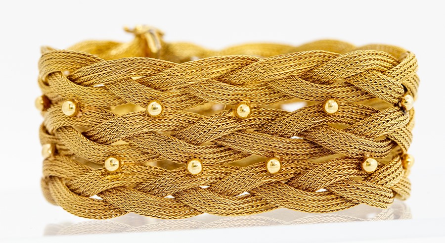 An 18ct gold woven link bracelet, comprising two rows of bead decoration to the centre, width