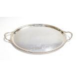 An Elizabeth II oval two handled silver tray, plain with gadroon border, by Barker Ellis Silver
