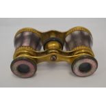 A pair of 19th Century French brass mounted black lip oyster shell opera glasses, stamped Lemaire