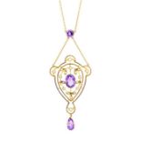 An Edwardian amethyst and seed pearl 9ct gold pendant, the open work pendant set to the centre