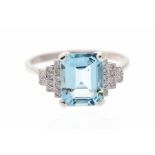 A platinum aquamarine and diamond ring, comprising a claw-set step-cut aquamarine, approx 10mm x