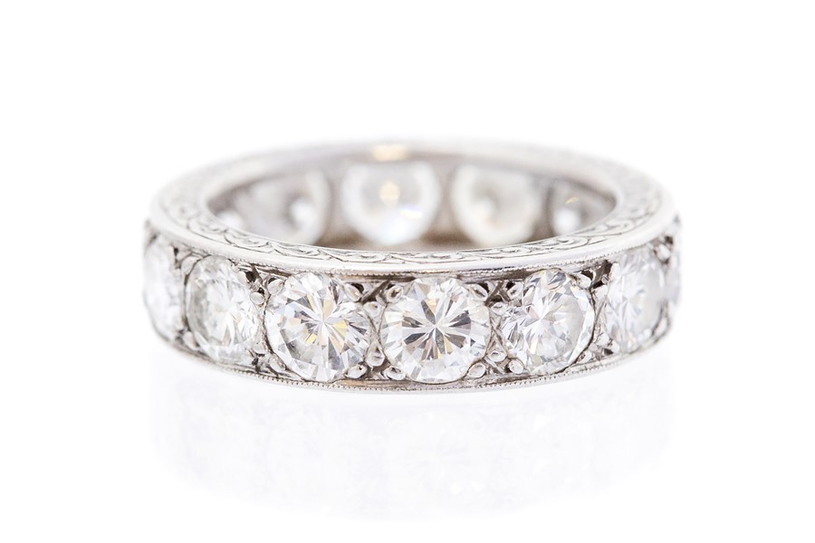 A diamond full set eternity platinum band ring, fourteen round brilliant-cut diamonds flush-grain