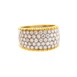 An 18ct white and yellow gold diamond set band ring, the front section with five rows of pave set