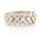 A diamond three row white gold ring, the front section claw set in three rows with a total of
