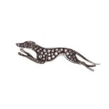 A diamond set brooch in the form of a greyhound in motion, the elongated body pave set with rose cut