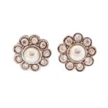 A pair of pearl and diamond set flower cluster earrings, untested pearls set to the centre approx