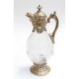 A Victorian glass and silver mounted claret jug, the silver chased with foliate decoration,